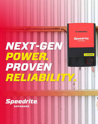 Speedrite U15000W electric Fence Charger with red and black case pink farm barn wall background