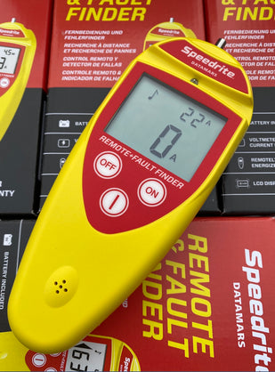 Yellow and red Speedrite Fault Finder and Remote Control ST102 on stack of others and turned on